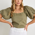 model wears a green linen puff sleeve top