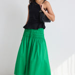 model wears a green poplin skirt