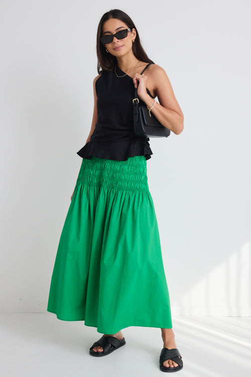 model wears a green poplin skirt