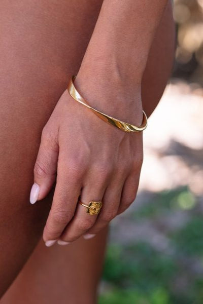 gold bangle on tan model