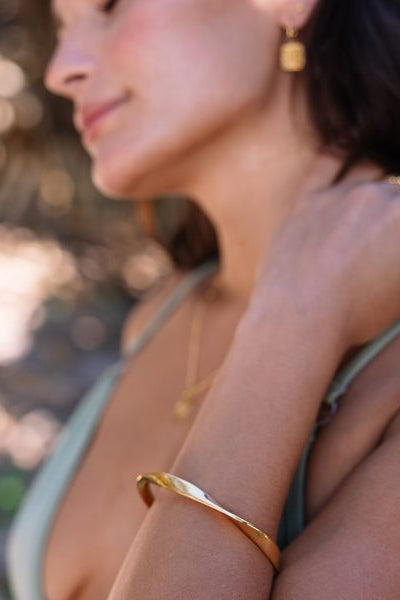 gold bangle on tan model