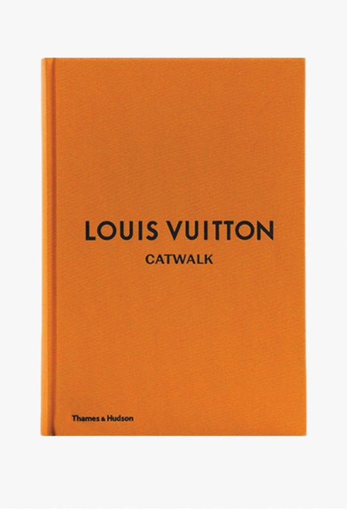 Orange book with 'Louis Vuitton Catwalk' text on a white background