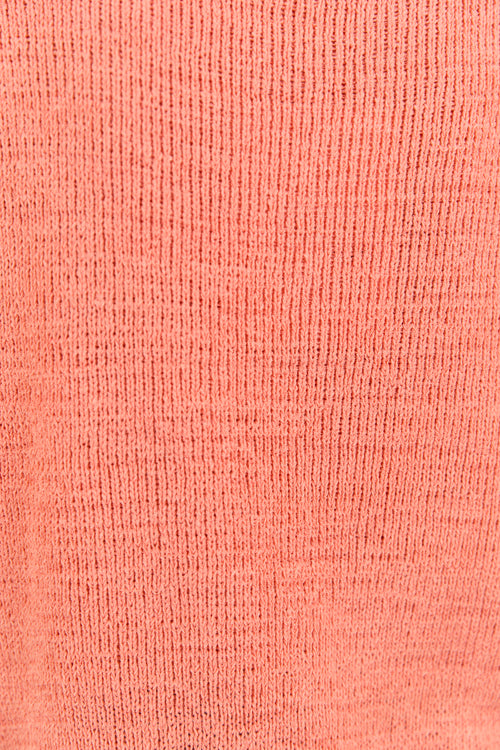Close up of orange shirt knit material.