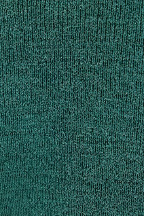 Close-up of a textured green fabric with a ribbed pattern