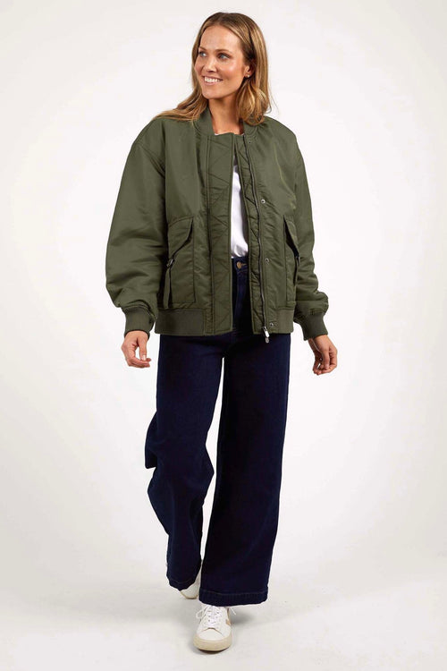 model wears a green bomber jacket