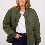 model wears a green bomber jacket