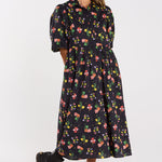 Woman wearing a floral dress on a white background