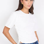 Woman wearing a white t-shirt and blue jeans on a white background
