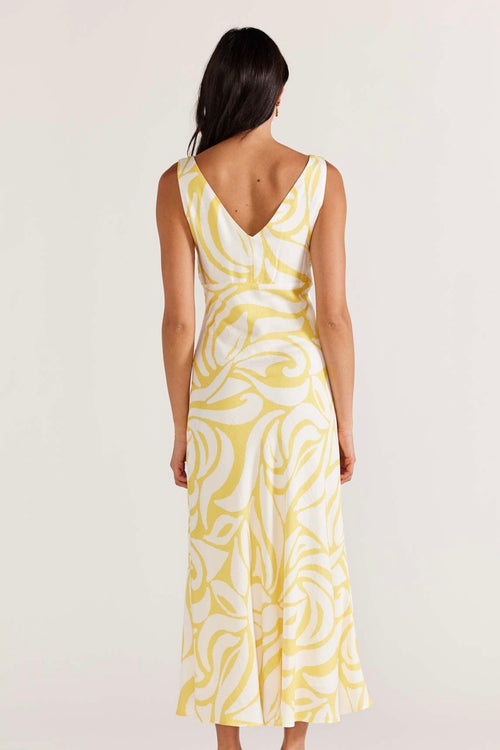 model wears yellow print maxi dress