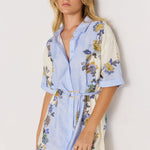 Woman wearing a floral dress with a white background