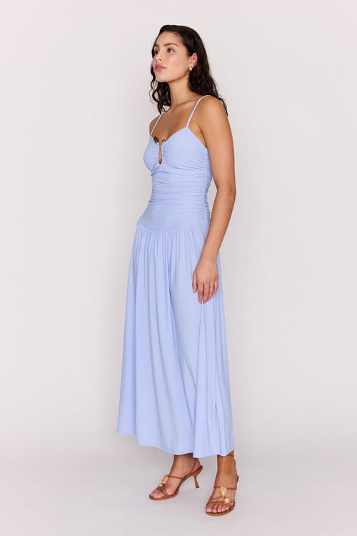 Woman wearing a light blue dress against a white background