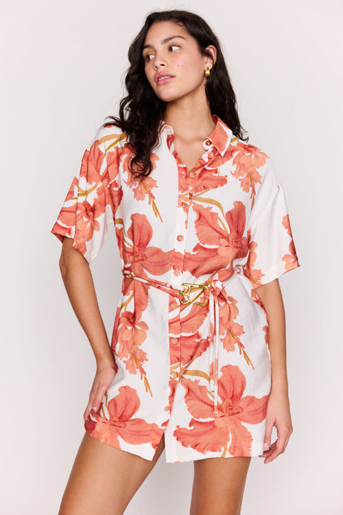 Woman wearing a floral dress with a plain background