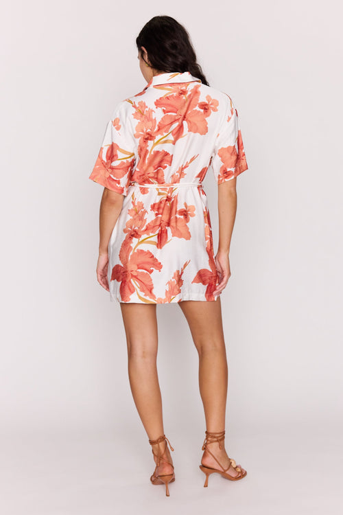 Woman wearing a floral dress on a plain background