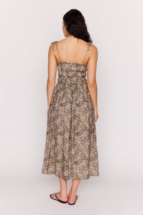 Woman wearing a floral dress against a white background