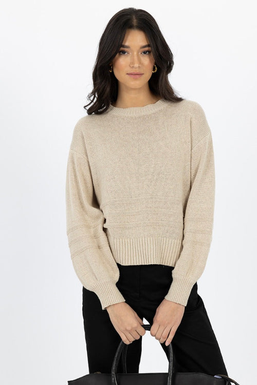 Model wears a beige knit