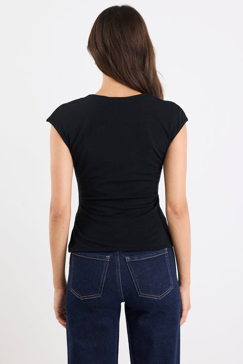 Person wearing a black t-shirt and blue jeans on a white background