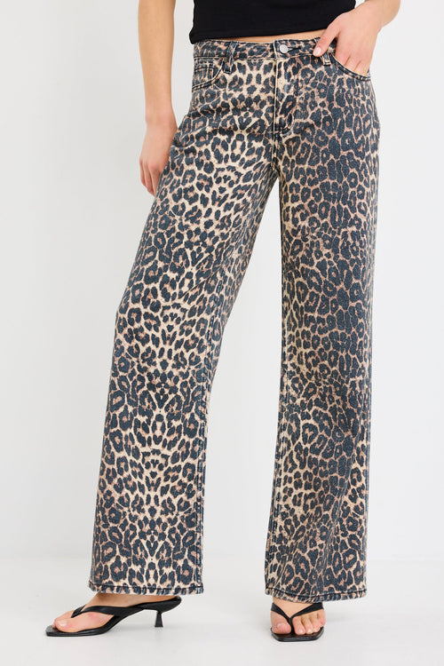 Leopard print pants worn by a person on a white background