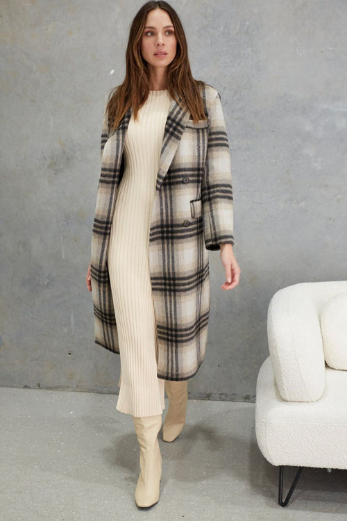 model wears a grey check wool coat