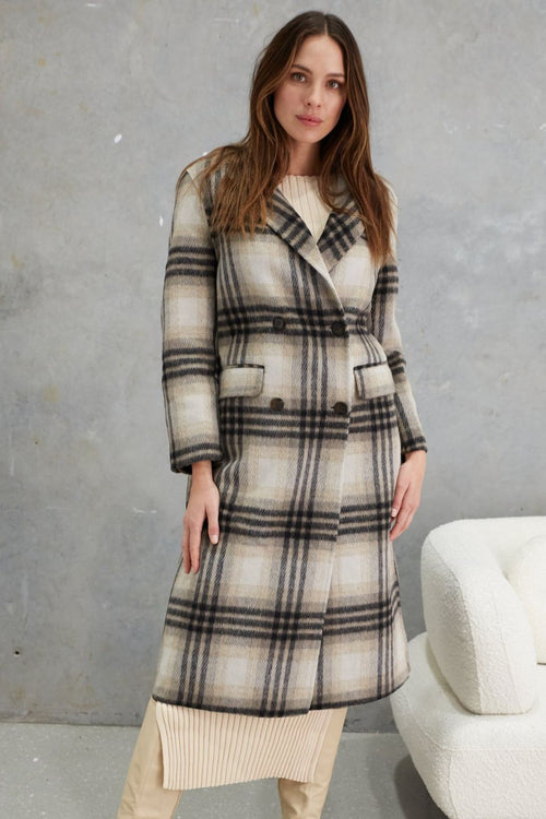 model wears a grey check wool coat