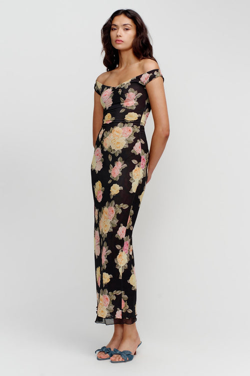 model wears a black floral maxi dress