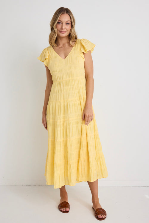 model wears a yellow flutter sleeve midi dress