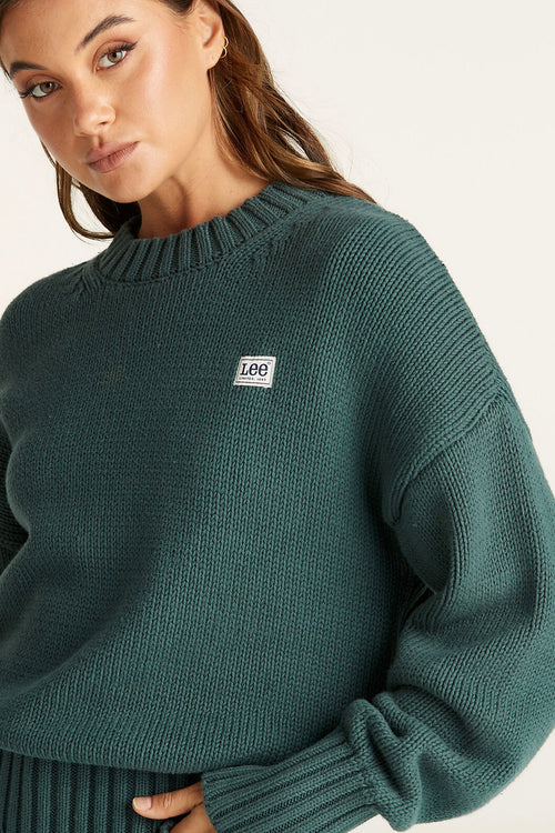 Model wears a Green Knit Sweater 