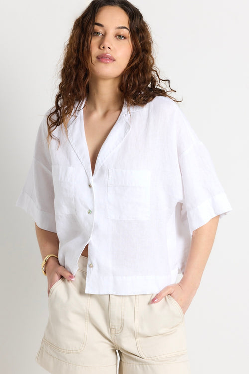 model wears a white linen shirt 