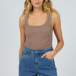 model wears brown tank top and blue jeans