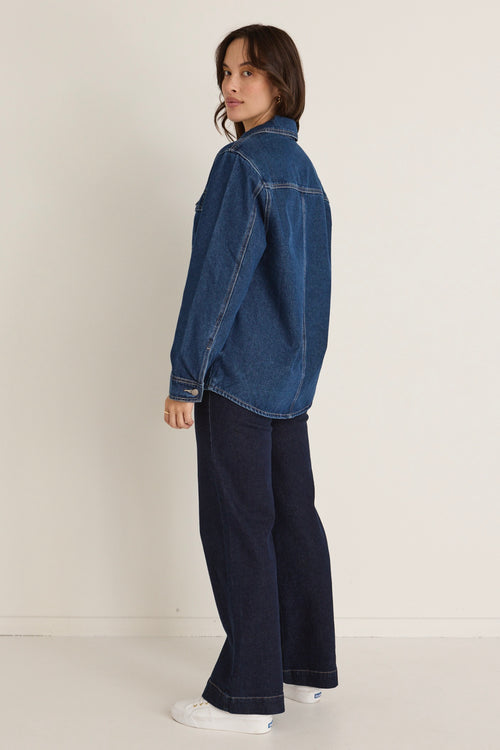 Model wears a denim jacket with jeans