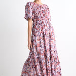 model wears a pink floral maxi dress