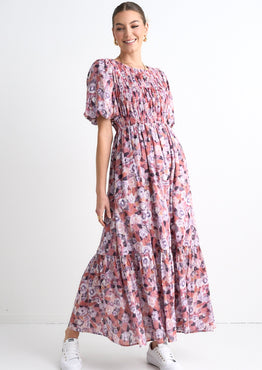 model wears a pink floral maxi dress