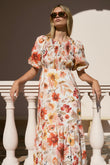 model wears a orange floral midi dress