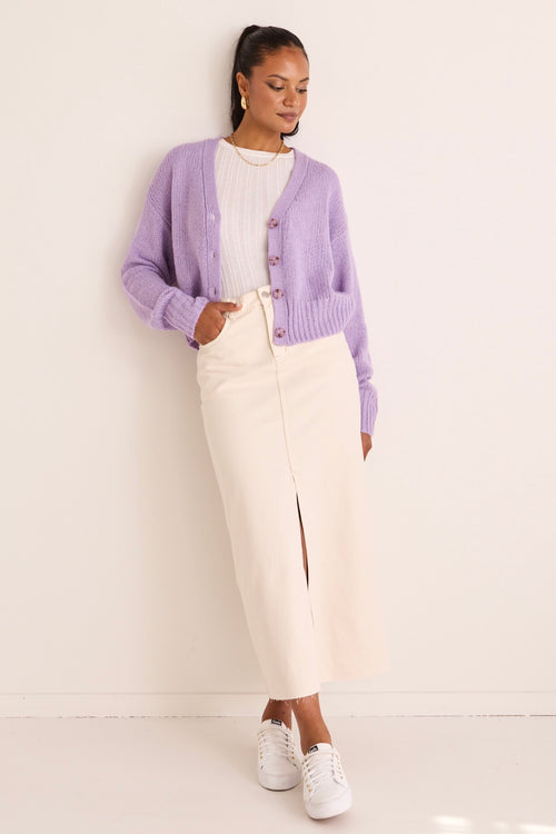 model wears a purple cardigan