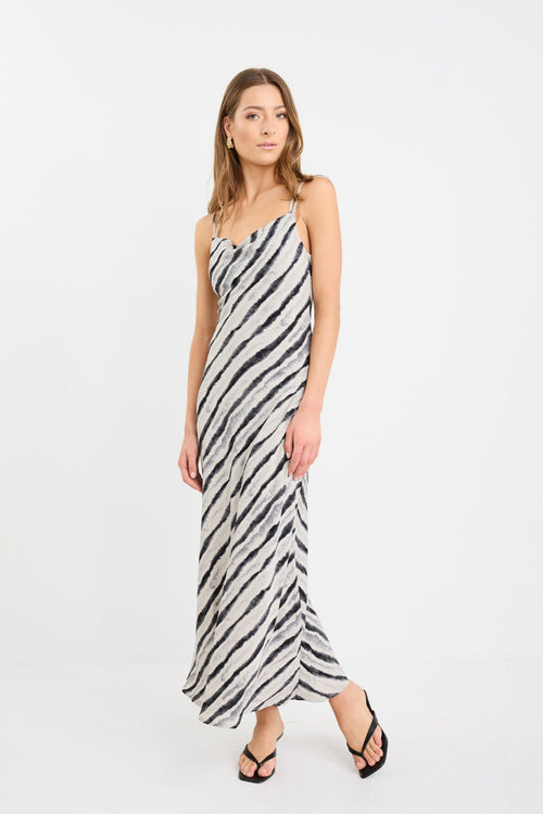 Woman wearing a zebra-striped dress on a white background