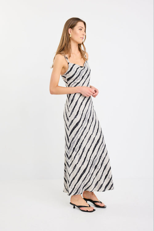 Woman wearing a black and white striped dress on a white background