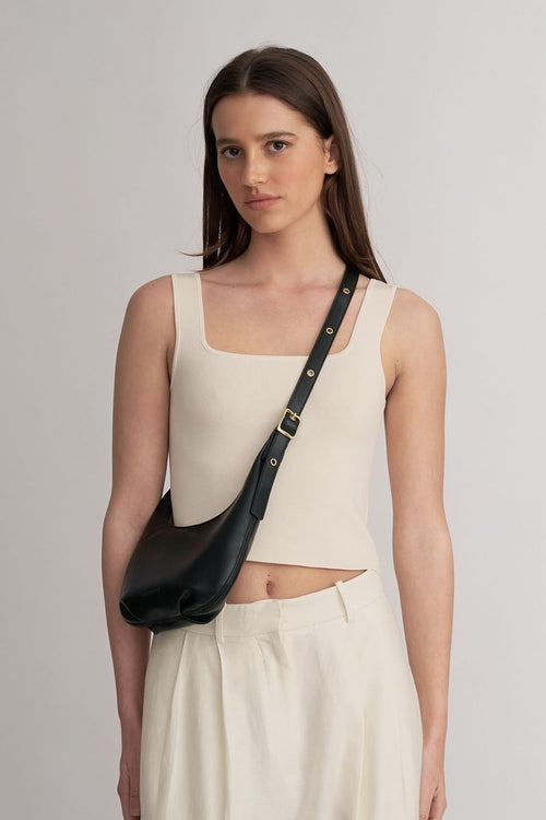 model wears a black handbag