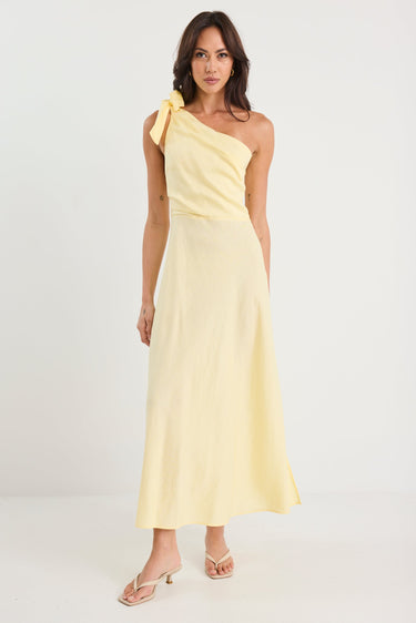 Woman wearing a yellow one-shoulder dress on a white background