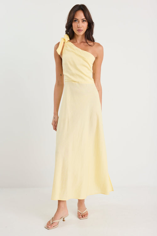 Woman wearing a yellow one-shoulder dress on a white background