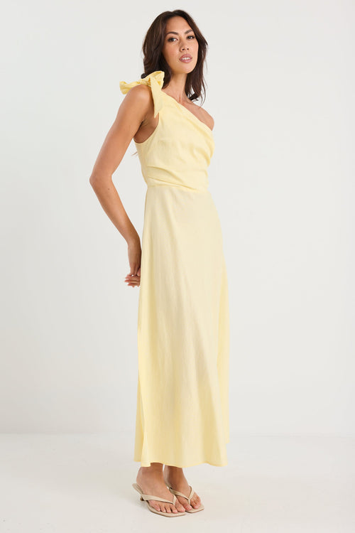 Woman wearing a light yellow one-shoulder dress on a white background