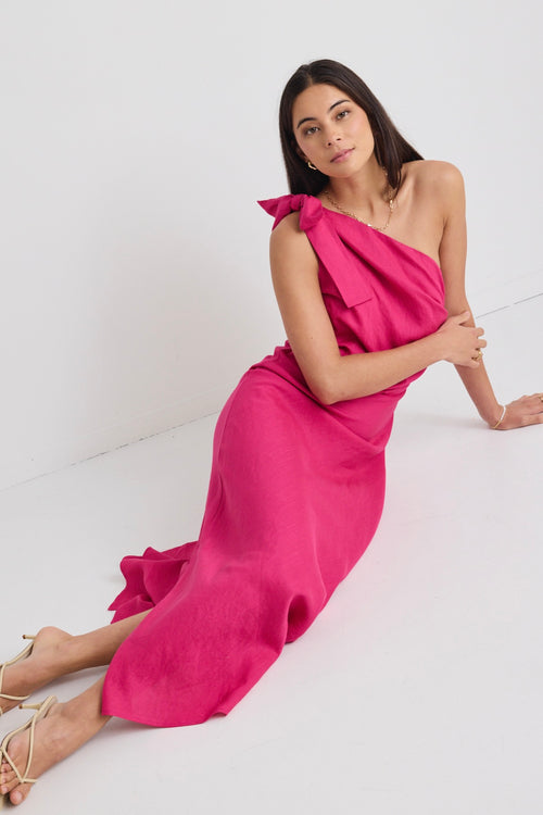 model wears a one shoulder pink midi dress