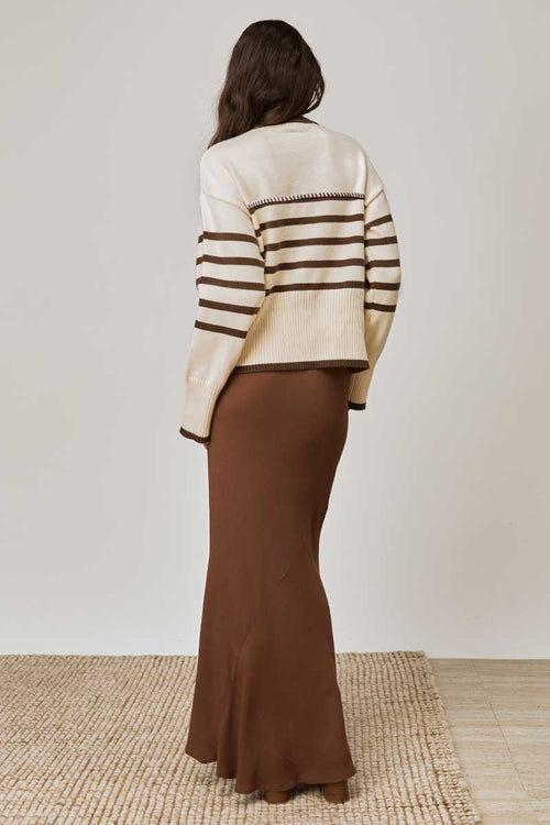 model wears a beige tan stripe knit