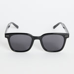 Glossy black classic square sunglasses with dark tinted lenses and subtle metal detailing, photographed on a white background.