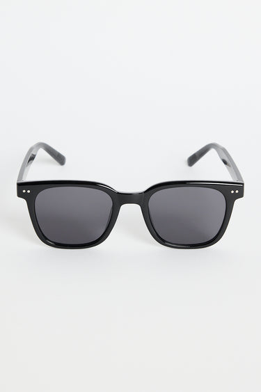 Glossy black classic square sunglasses with dark tinted lenses and subtle metal detailing, photographed on a white background.