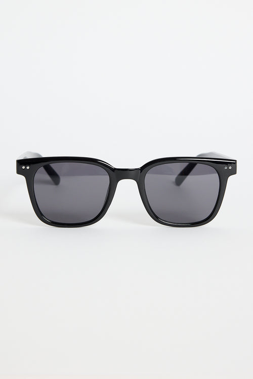 Glossy black classic square sunglasses with dark tinted lenses and subtle metal detailing, photographed on a white background.