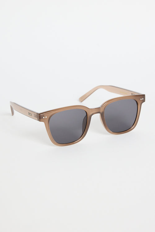 Translucent brown classic square sunglasses with dark tinted lenses, photographed on a white background.