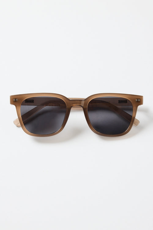 Translucent brown classic square sunglasses with dark tinted lenses, photographed on a white background.