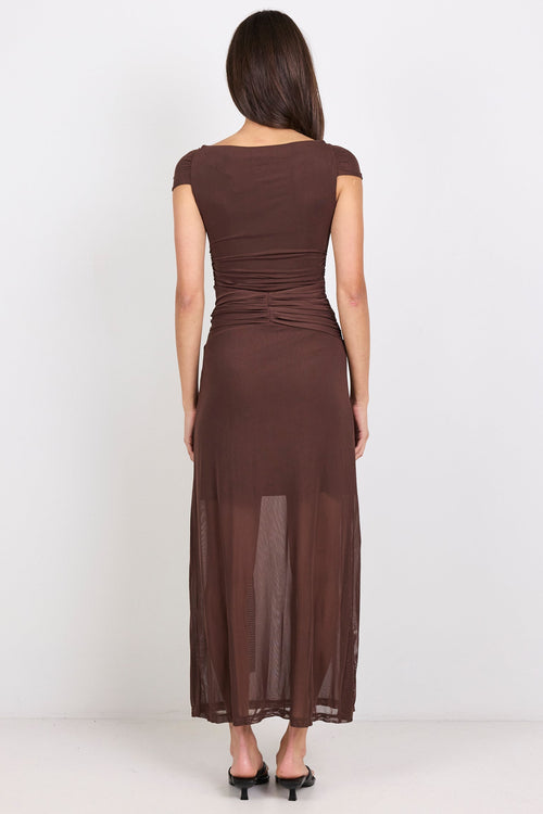 Woman wearing a brown dress on a white background