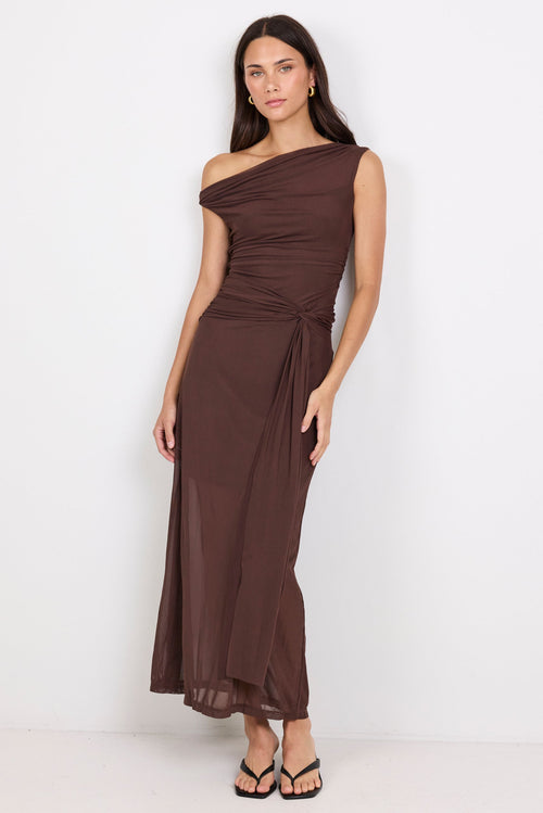 Woman wearing a brown one-shoulder dress on a white background