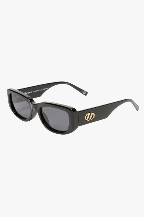 Black rectangular sunglasses with narrow frames and khaki-tinted mono lenses.