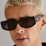 Black rectangular sunglasses with narrow frames and khaki-tinted mono lenses.